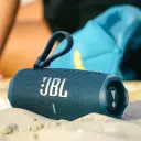 JBL Charge 6 JBLCHARGE6 in blue with carry loop resting on beach sand, lifestyle shot - CairoVolt