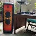 JBL PartyBox 1000 JBLPARTYBOX1000 with orange lightshow outdoors next to a DJ controller setup - CairoVolt