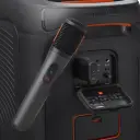 JBL PartyBox Wireless Mic JBLPBWIRELESSMIC leaning on a PartyBox speaker with receiver plugged into mic port - CairoVolt