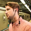 Man wearing JBL T110BT JBLT110BT wireless neckband earphones on a metro platform - CairoVolt