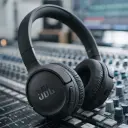 JBL Tune 520BT JBLT520BT black headphones resting on a studio mixing console - CairoVolt
